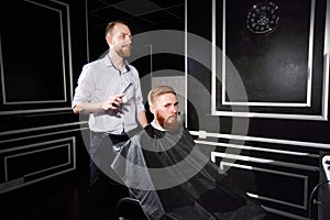 Confident man visiting hairstylist in barber shop.