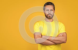 confident man wear yellow tshirt on background, copy space. man wear yellow tshirt in studio.