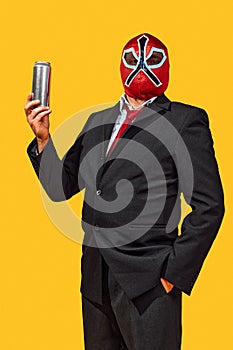Confident man in wrestler attire with mask in official attire holds aluminum cane against yellow studio background. Ad