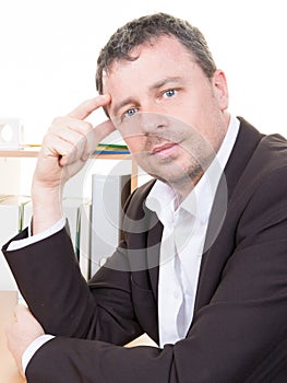 confident manager man sitting at desk and looking at camera smiling businessman working at office