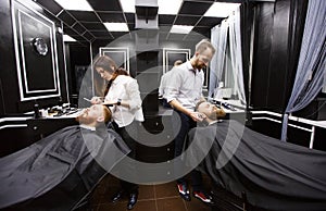 Confident mans visiting hairstylists in barber shop.