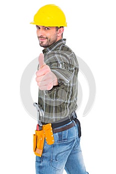 Confident manual worker gesturing thumb up