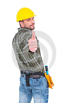 Confident manual worker gesturing thumb up