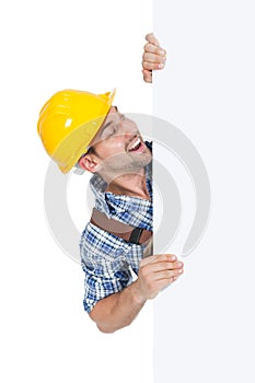 Confident manual worker holding billboard