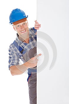 Confident manual worker holding billboard