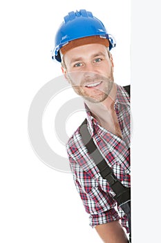 Confident Manual Worker Holding Billboard