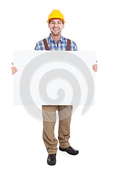 Confident manual worker holding billboard