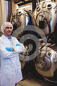 Confident manufacturer standing at brewery