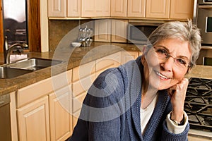Confident mature older woman at home.