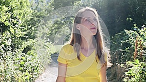 Confident mature woman walking while relaxing looking arround her in the mountain.