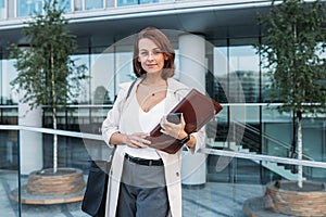 Confident middle-aged female holding a folder