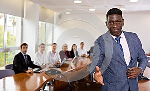 Confident middle-aged mature african businessman giving hand for handshake