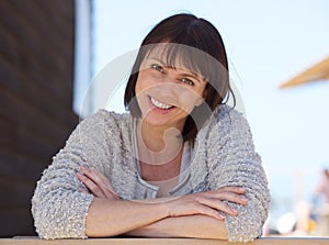 Confident middle aged woman smiling outside