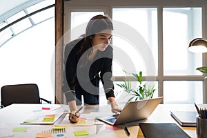 Confident millennial indian female business analyst preparing statistic report photo