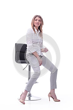 Confident modern woman sitting on a chair . isolated on white background