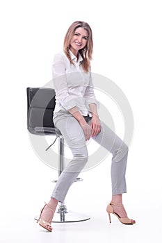 Confident modern woman sitting on a chair . isolated on white background