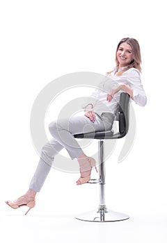 Confident modern woman sitting on a chair . isolated on white background