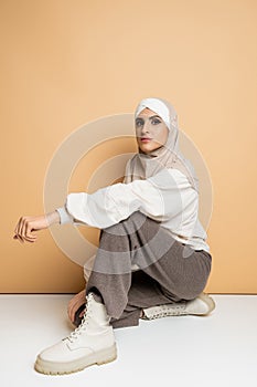 confident muslim woman in hijab, grey