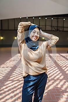 Confident muslim woman standing in a shopping mall with shadow effects