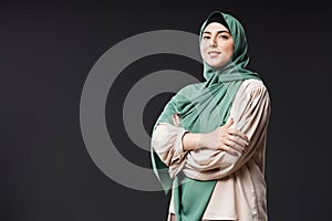 Confident Muslim Woman Wearing Modest Clothing on Black Background