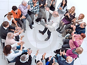 confident older man standing in a circle of like-minded people