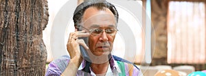 Confident older man talking on a mobile phone