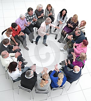 confident older woman standing in a circle of like-minded people