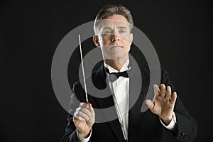 Confident Orchestra Conductor Directing With His Baton