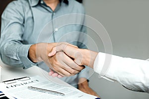 Confident partnerships people shaking hands with making a contract in the office