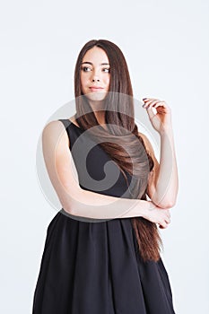 Confident pensive young woman with beautiful long dark hair
