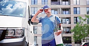 Confident Pest Control Worker Wearing Cap Against