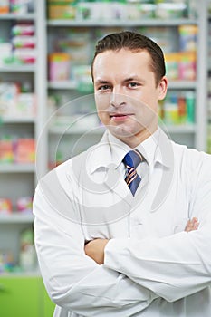 Confident pharmacy chemist man in drugstore photo