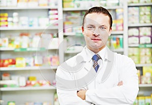 Confident pharmacy chemist man in drugstore photo