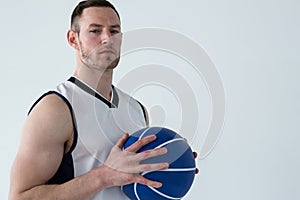 Confident player holding basketball