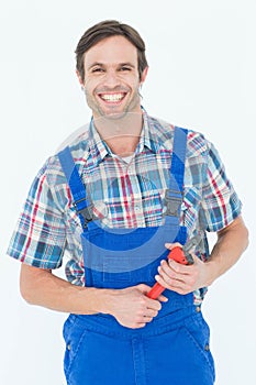 Confident plumber holding monkey wrench