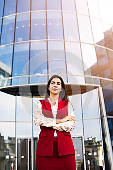 Confident pondering female entrepreneur outside