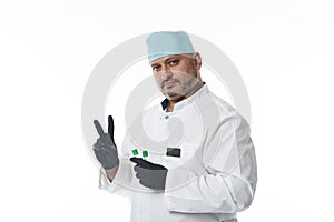 Confident portrait of handsome doctor in medical uniform, looking at camera standing isolated on white background with copy space