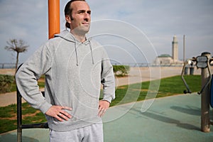 Confident portrait of a sportsman exercising outdoor on the urban sportsground