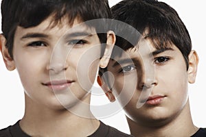 Confident Preadolescent Siblings Against White Background photo