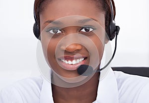 Confident receptionist using headset in hospital