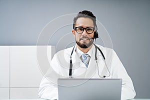 Confident Receptionist Using Headset In Hospital