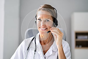 Confident Receptionist Using Headset In Hospital
