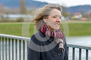 Confident relaxed woman crossing a bridge