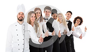 Confident Restaurant Staff Gesturing Thumbs Up