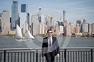 Confident rich business man executive standing in New York City. Business American success. American business dream