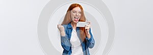 Confident and sassy good-looking redhead woman beat score, watching tennis match online on smartphone and cheering for