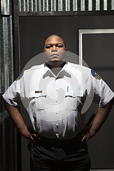 Confident Security Guard Standing At Corrugated Doorway