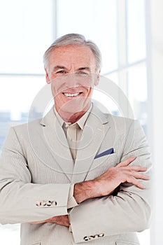 Confident senior businessman with folded arms