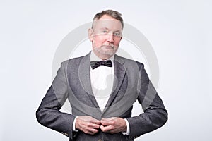 Confident senior businessman in formal suit posing smiling