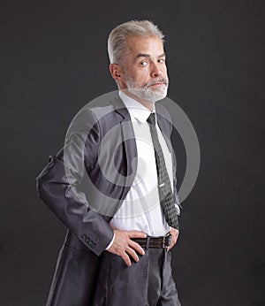 Confident senior businessman. isolated on dark background